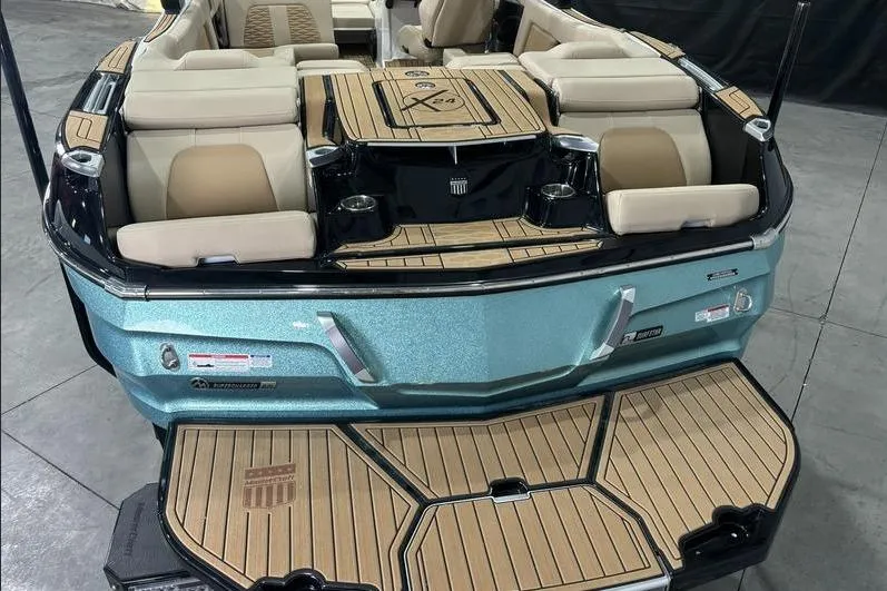 Slide: The Image of 2024 MasterCraft X24 boat with luxurious seating and teak-style decking. - 12
