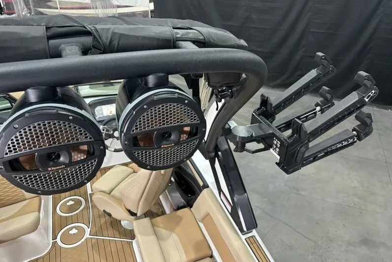 Slide: The Image of 2024 MasterCraft X24 boat with speakers and wakeboard rack, featuring luxury seating. - 15