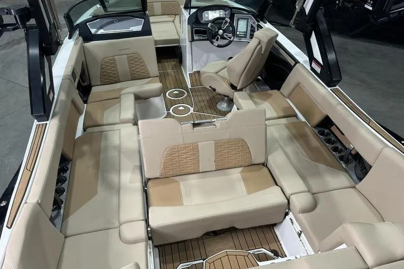 Slide: The Image of 2024 MasterCraft X24 boat interior with luxurious beige seating and modern dashboard. - 5
