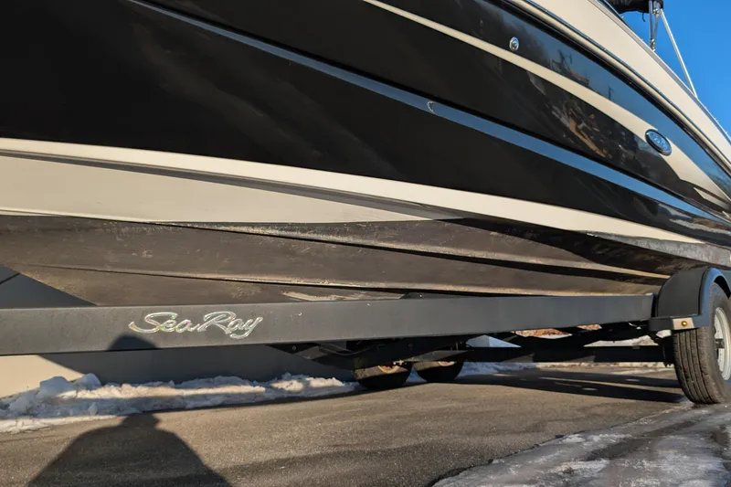 Slide: The Image of 2011 Sea Ray 240 Sundeck boat on trailer, side view in sunlight. - 2