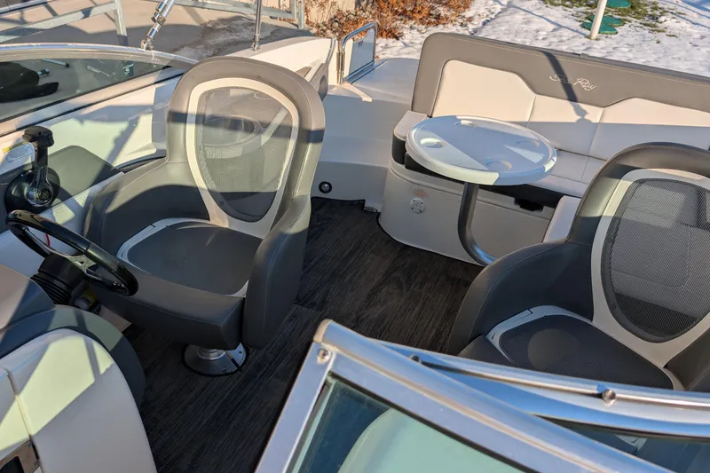 Slide: The Image of 2011 Sea Ray 240 Sundeck interior with seating and table, showcasing modern design. - 20