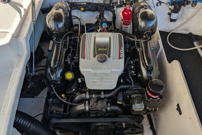 Slide: The Image of Engine compartment of a 2011 Sea Ray 240 Sundeck boat, featuring a 5.0L V8 engine. - 21