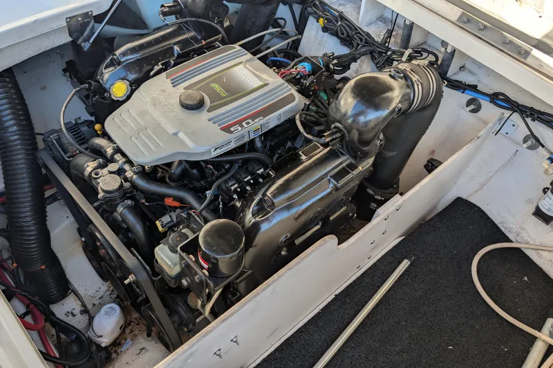 Slide: The Image of Engine compartment of a 2011 Sea Ray 240 Sundeck boat, featuring a MerCruiser 5.0 MPI engine. - 23