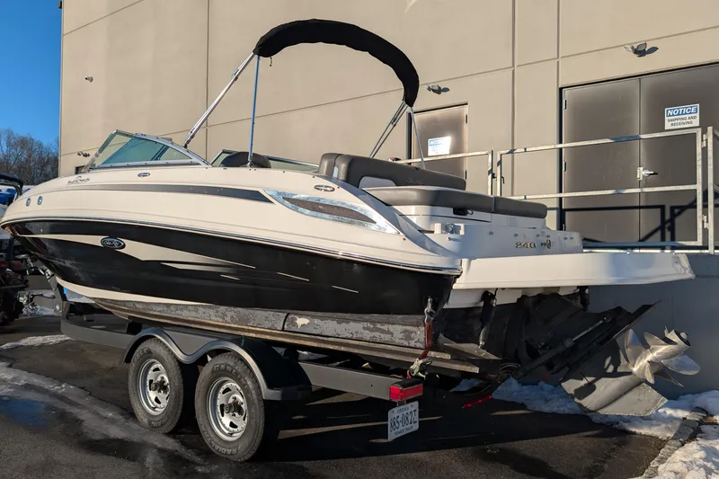 Slide: The Image of 2011 Sea Ray 240 Sundeck boat on trailer, parked outdoors. - 3