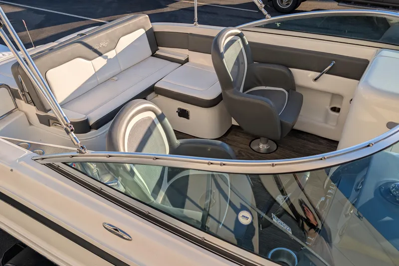 Slide: The Image of 2011 Sea Ray 240 Sundeck interior with seating and steering wheel, showcasing luxury design. - 8