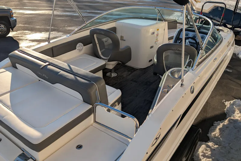 Slide: The Image of 2011 Sea Ray 240 Sundeck boat interior with seating and steering wheel. - 9