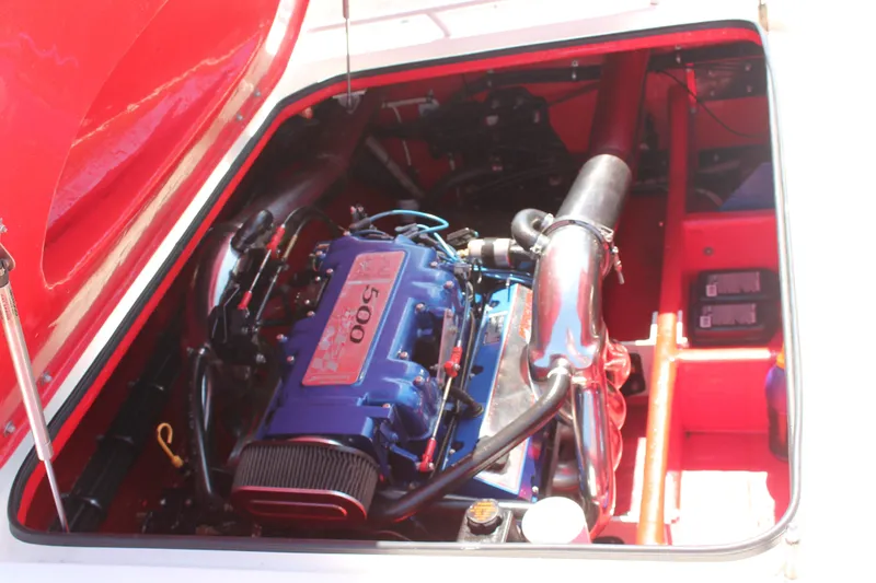 Slide: The Image of 2004 Spectre 36 Cat engine compartment with vibrant red and blue components. - 11