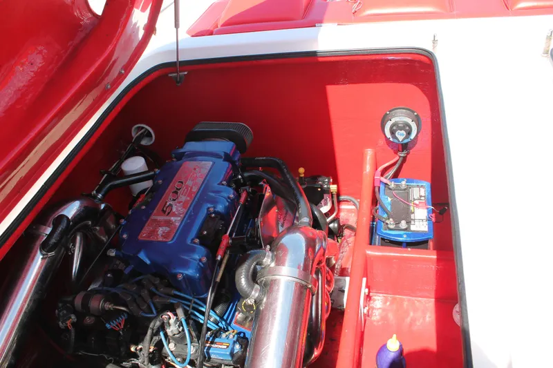 Slide: The Image of 2004 Spectre 36 Cat engine compartment with blue 500 EFI engine and battery. - 16