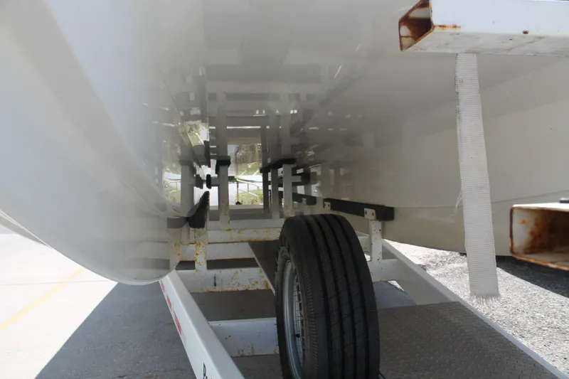 Slide: The Image of Underneath view of a 2004 Spectre 36 Cat boat on a trailer. - 17