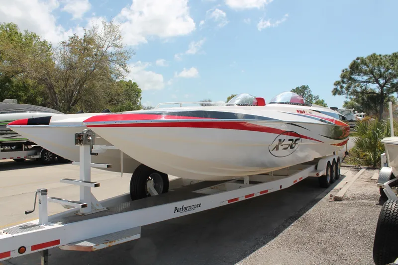 Slide: The Image of 2004 Spectre 36 Cat powerboat on trailer, featuring sleek design and vibrant red accents. - 3