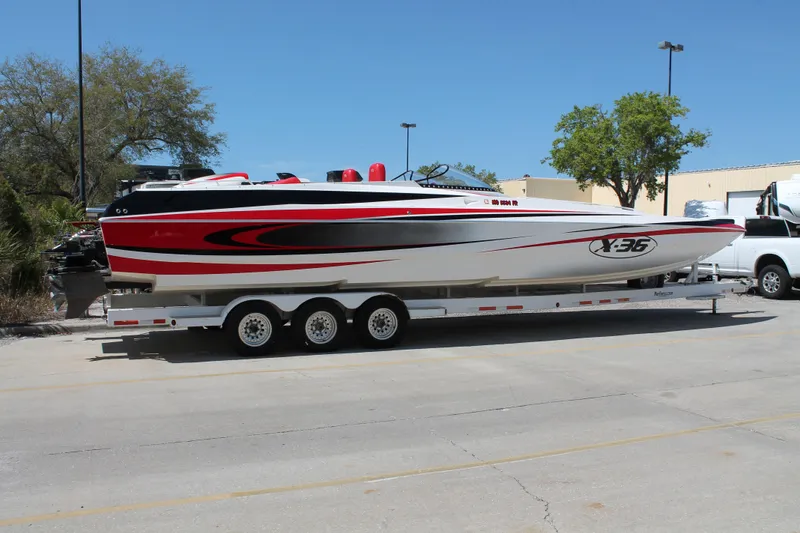 Slide: The Image of 2004 Spectre 36 Cat powerboat on trailer, featuring sleek red and black design. - 5