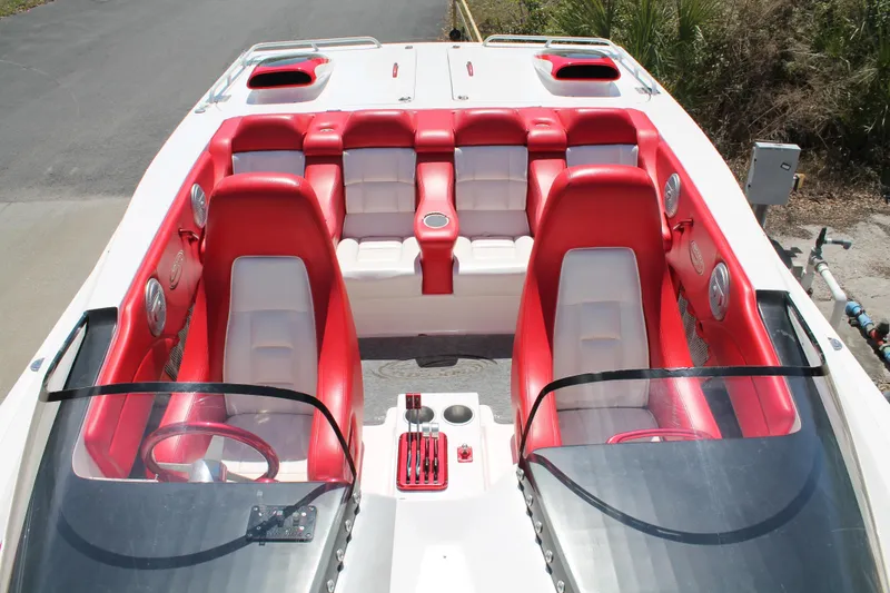 Slide: The Image of 2004 Spectre 36 Cat boat interior with red and white seating, dual steering wheels. - 8