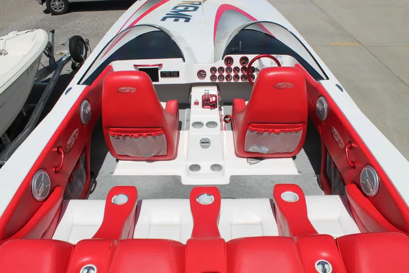 Slide: The Image of 2004 Spectre 36 Cat boat interior with red and white seating, dashboard, and controls. - 9
