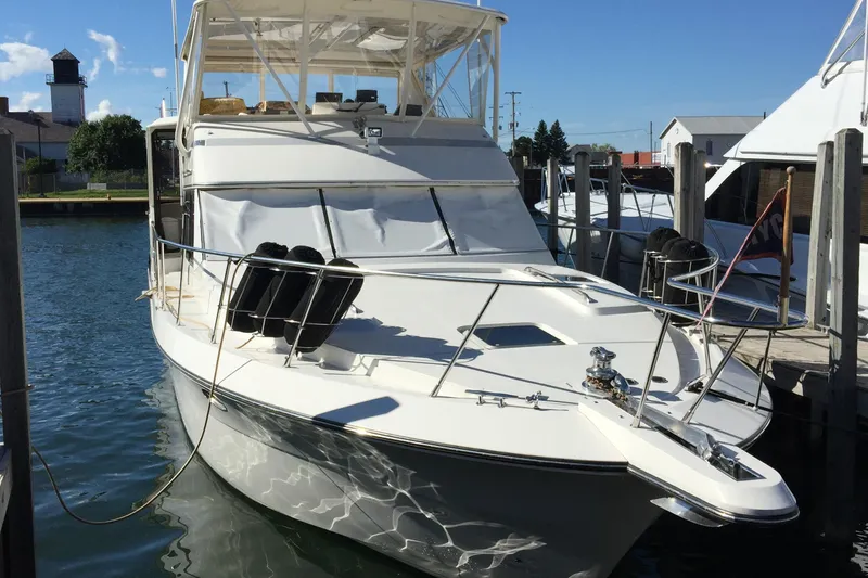 Slide: The Image of 1989 Dyna Craft 45 yacht docked in a marina under clear blue skies. - 10