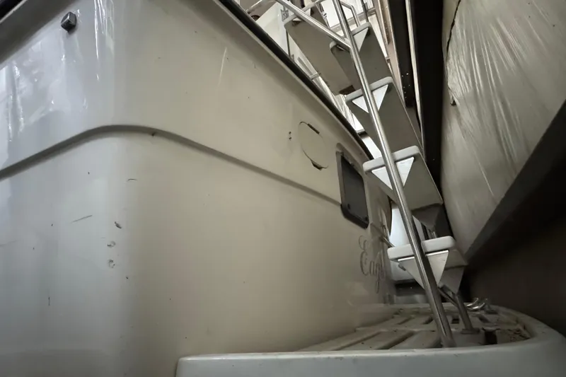 Slide: The Image of 1989 Dyna Craft 45 boat with metal ladder, docked indoors. - 17