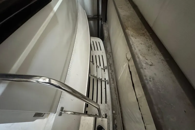 Slide: The Image of Interior view of a 1989 Dyna Craft 45 boat, showing seating and railing. - 18