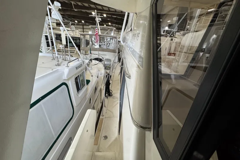 Slide: The Image of 1989 Dyna Craft 45 yacht docked indoors, side view with adjacent boats. - 20