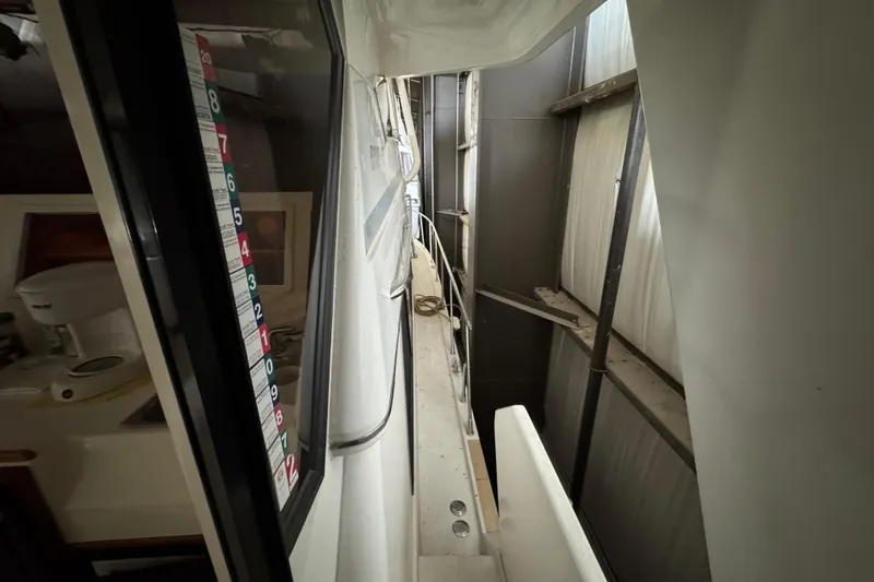 Slide: The Image of 1989 Dyna Craft 45 yacht interior with narrow passage and visible equipment. - 21