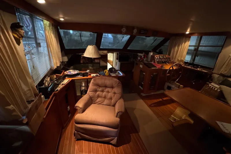 Slide: The Image of Cozy interior of a 1989 Dyna Craft 45 yacht with plush seating and wooden accents. - 24