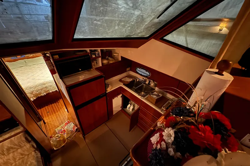 Slide: The Image of Interior of 1989 Dyna Craft 45 yacht with kitchen and cozy bedroom. - 26