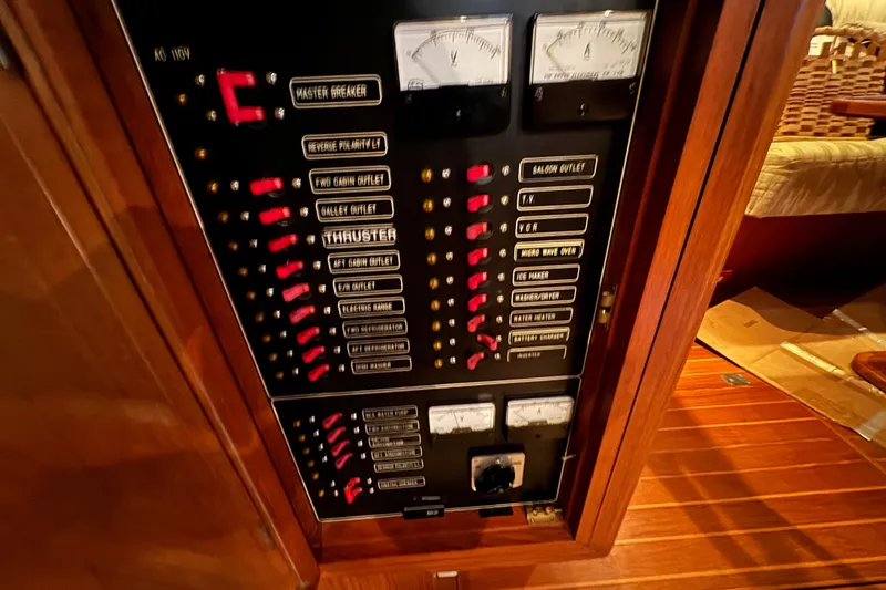 Slide: The Image of Electrical control panel on 1989 Dyna Craft 45 yacht, featuring various labeled switches and gauges. - 30