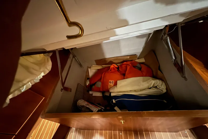 Slide: The Image of Storage compartment on 1989 Dyna Craft 45 boat with life jackets and gear. - 35