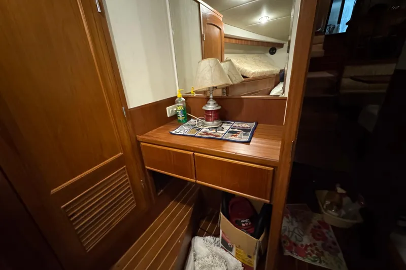 Slide: The Image of 1989 Dyna Craft 45 yacht interior with wooden vanity, lamp, and cozy decor. - 37
