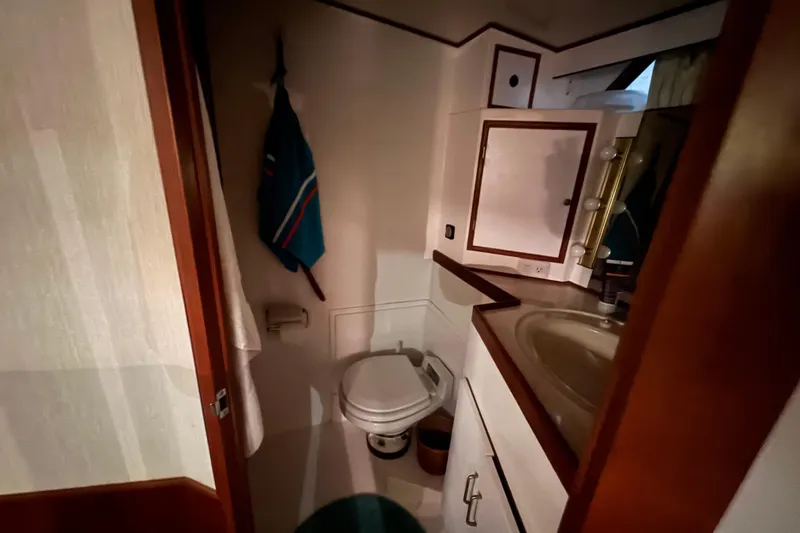 Slide: The Image of Compact bathroom in 1989 Dyna Craft 45 yacht, featuring sink, toilet, and storage. - 39