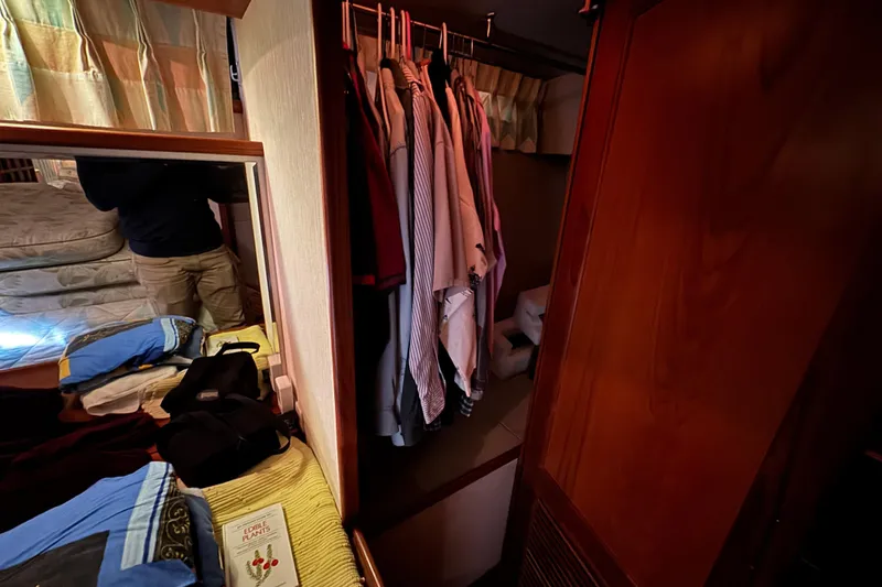 Slide: The Image of Interior of 1989 Dyna Craft 45 yacht with clothes hanging in a closet. - 42