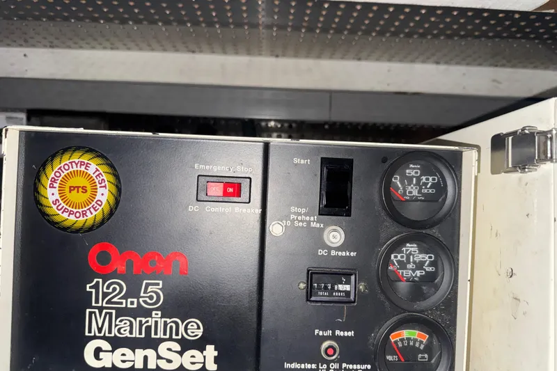 Slide: The Image of Onan 12.5 Marine GenSet control panel with gauges and emergency stop switch. Dyna Craft 1989. - 47