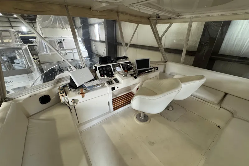 Slide: The Image of Interior of 1989 Dyna Craft 45 yacht with helm station and white seating. - 48