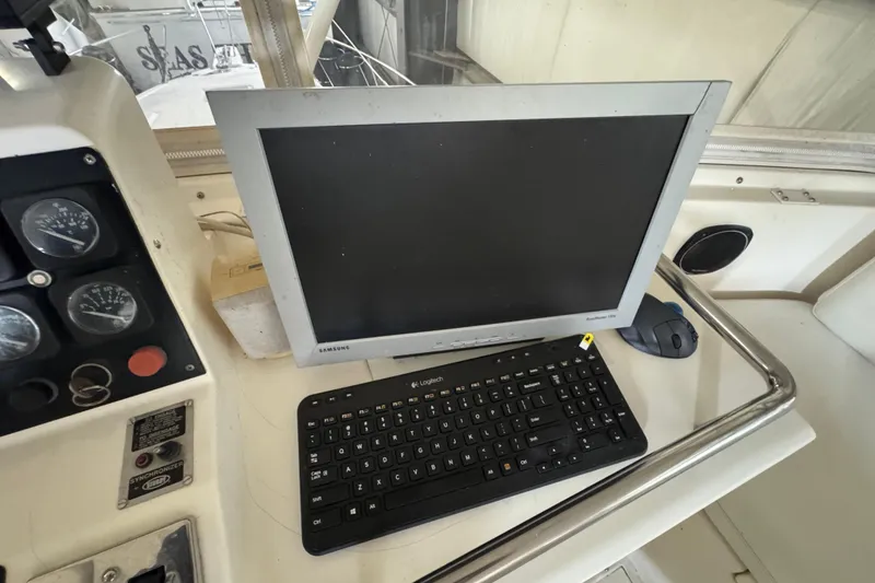 Slide: The Image of 1989 Dyna Craft 45 yacht dashboard with Samsung monitor and Logitech keyboard. - 52