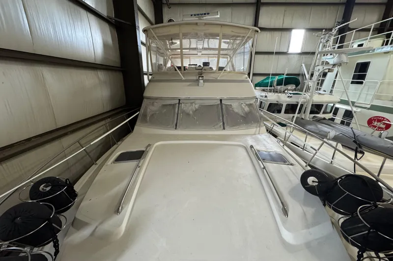 Slide: The Image of 1989 Dyna Craft 45 yacht in storage, showcasing its deck and cabin structure. - 55