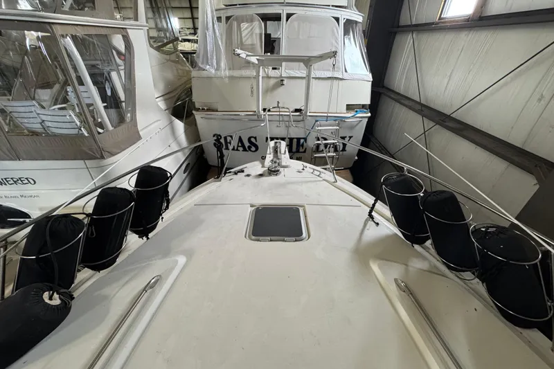 Slide: The Image of 1989 Dyna Craft 45 yacht docked indoors, surrounded by other boats. - 56