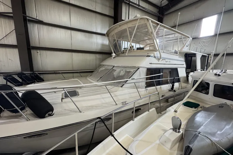 Slide: The Image of 1989 Dyna Craft 45 yacht in indoor storage, showcasing sleek design and spacious deck. - 58