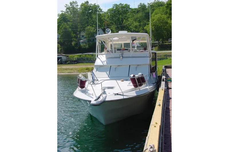 Slide: The Image of 1989 Dyna Craft 45 yacht docked on a sunny day with lush greenery. - 6