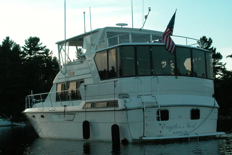 Slide: The Image of 1989 Dyna Craft 45 yacht docked on calm water, featuring an American flag. - 8