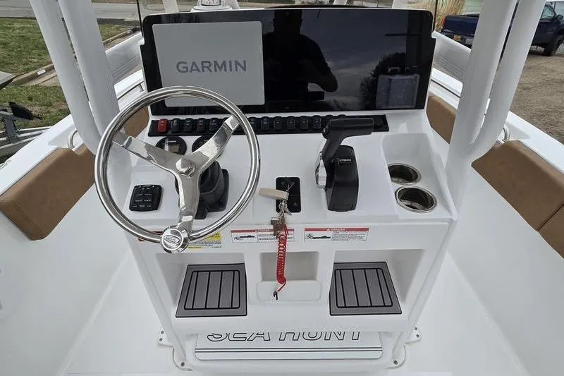 Slide: The Image of 2024 Sea Hunt Ultra 234 boat console with Garmin display and steering wheel. - 11