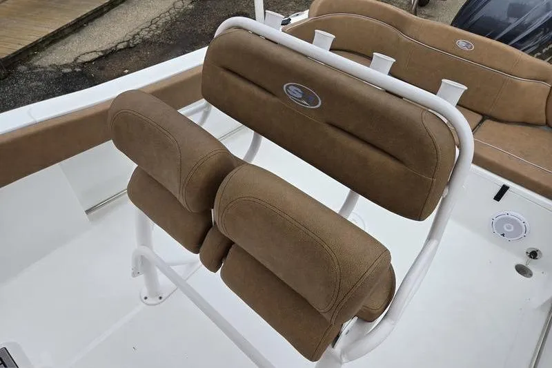 Slide: The Image of 2024 Sea Hunt Ultra 234 boat seating with brown cushions and white frame. - 15