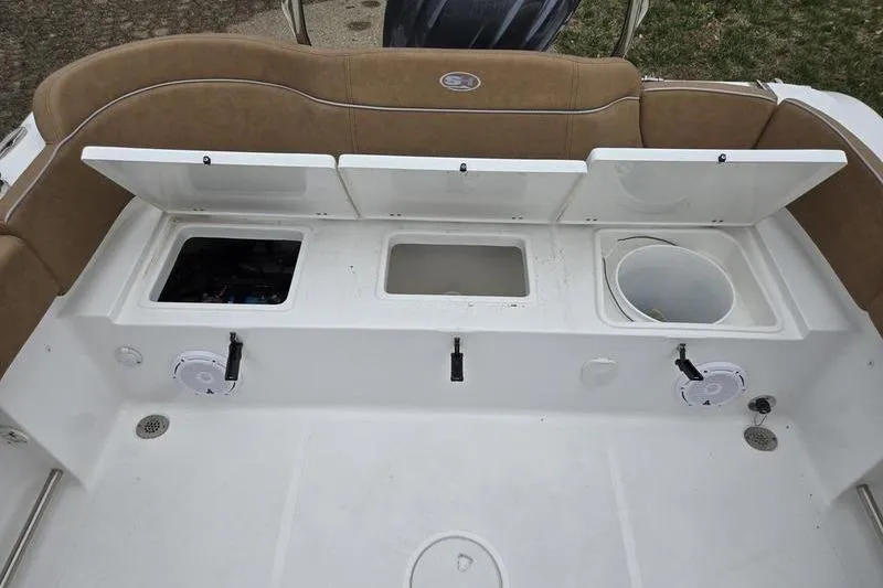 Slide: The Image of 2024 Sea Hunt Ultra 234 boat storage compartments and seating area. - 18