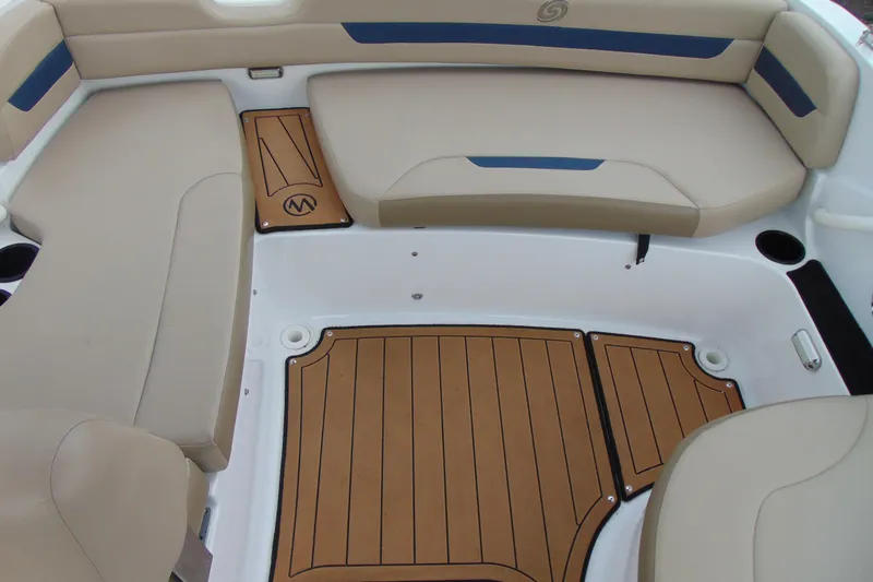 Slide: The Image of 2023 Hurricane SunDeck Sport 185 OB boat interior with beige seating and wood-style flooring. - 10