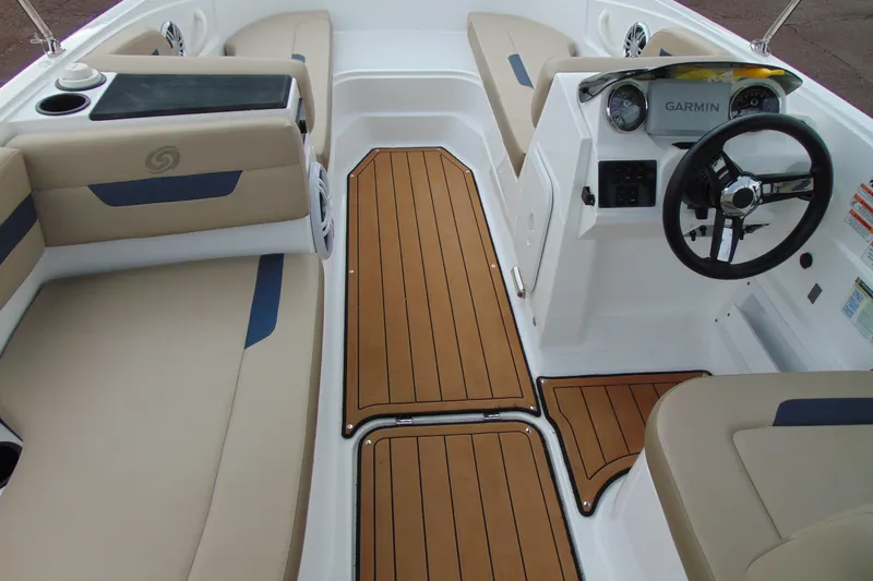 Slide: The Image of 2023 Hurricane SunDeck Sport 185 OB interior with tan seating and Garmin dashboard. - 11
