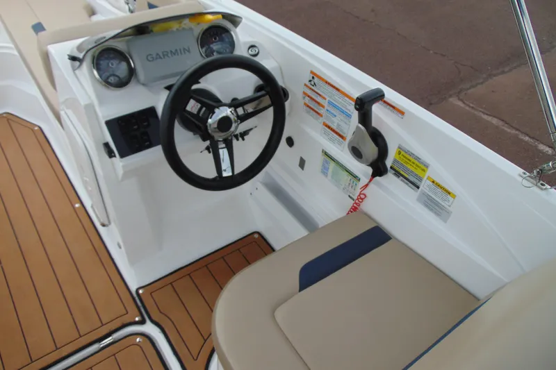 Slide: The Image of 2023 Hurricane SunDeck Sport 185 OB boat cockpit with Garmin navigation and tan seating. - 13