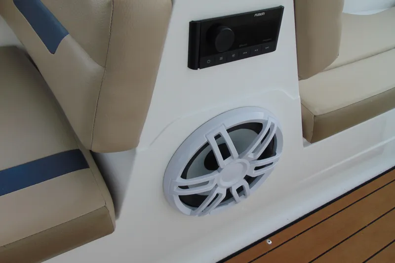 Slide: The Image of 2023 Hurricane SunDeck Sport 185 OB boat interior with speaker and beige seating. - 15