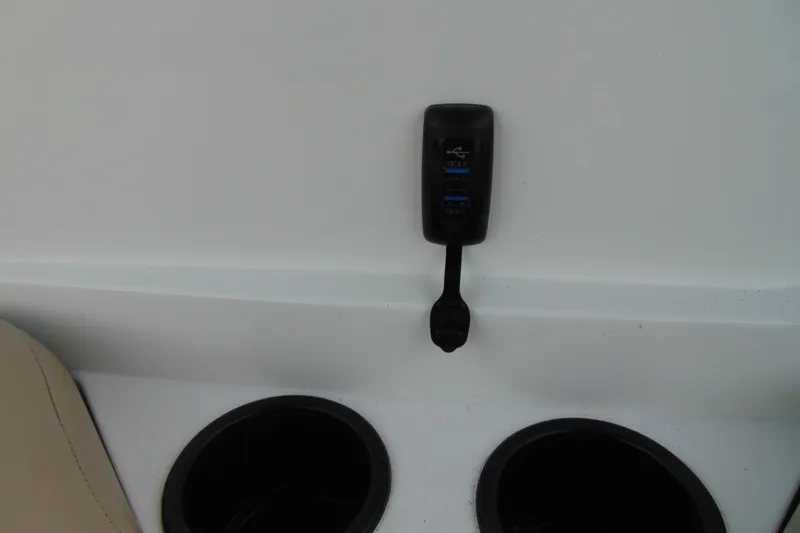 Slide: The Image of 2023 Hurricane SunDeck Sport 185 OB interior with USB ports and cup holders. - 18