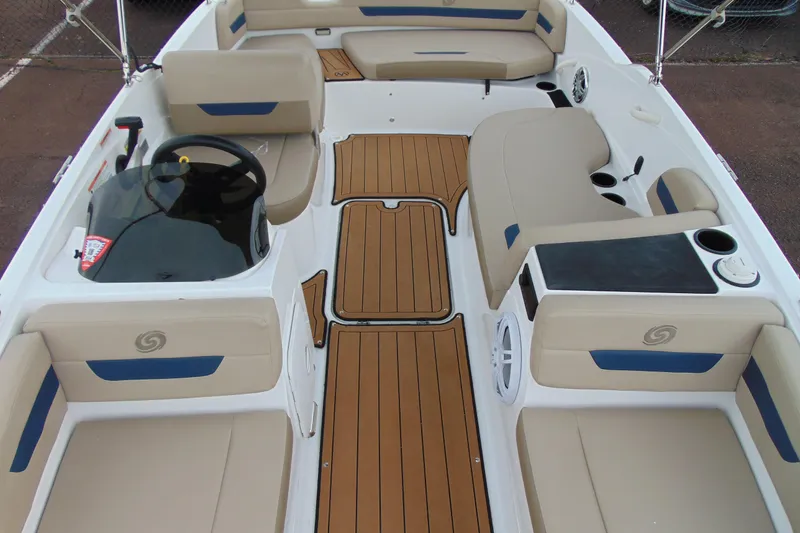 Slide: The Image of 2023 Hurricane SunDeck Sport 185 OB interior with tan seating and wood-style flooring. - 22