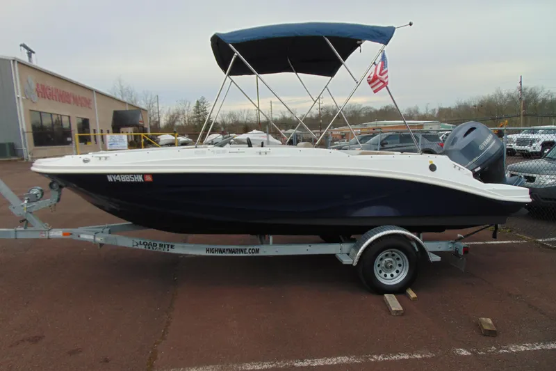 Slide: The Image of 2023 Hurricane SunDeck Sport 185 OB boat on trailer, parked at Highway Marine. - 5