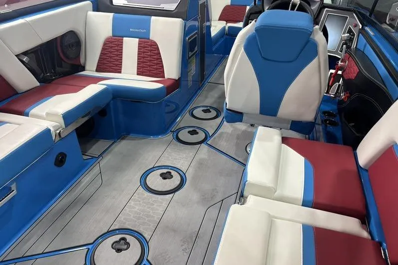 Slide: The Image of 2024 MasterCraft X24 interior with blue, white, and red seating, showcasing modern design. - 10
