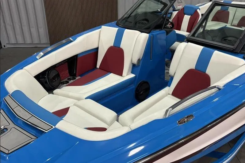 Slide: The Image of 2024 MasterCraft X24 boat interior with blue, white, and red seating. - 12