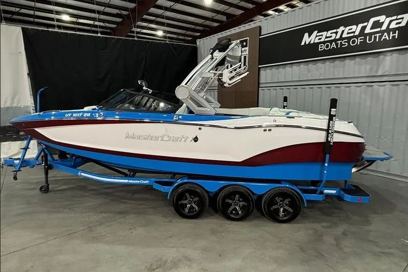 Slide: The Image of 2024 MasterCraft X24 boat on trailer in showroom, MasterCraft Boats of Utah. - 4
